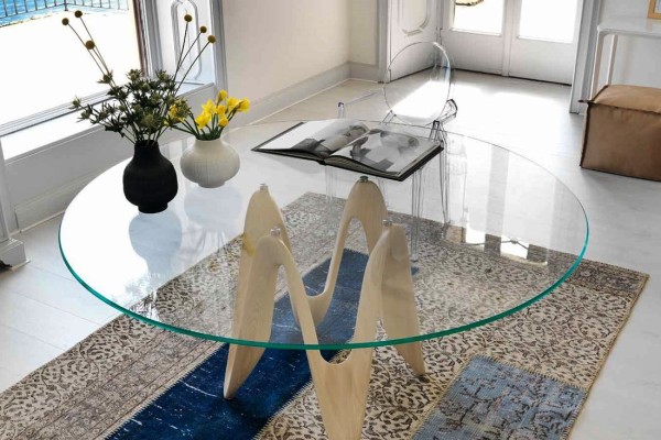 Do what I used to do: Buy a (removable) glass-topped dining table with an awesome base.  Then invest in a smaller glass table top that is the size of the table base. When you're not using it as a dining table, place the small glass piece on top and use it as an accent or side table, and store the larger glass top.