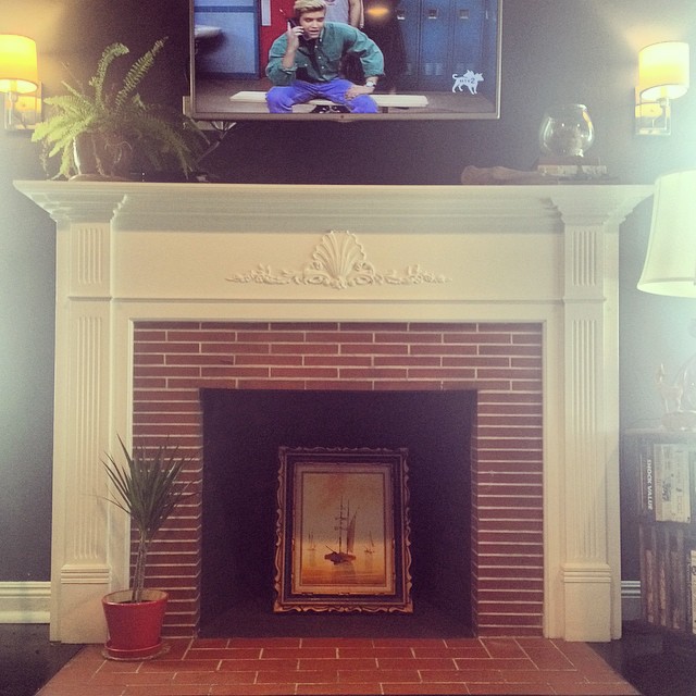 non-functional fireplaces are a great place to show off art