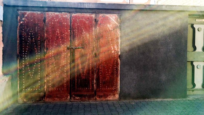 red door on grey wall in morocco